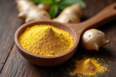 The primary subject of the image is a wooden spoon filled with a yellow substance, likely a spice or a sauce. The spoon is placed on a wooden table, which serves as the setting for the scene. The visual style of the image is a close-up of the spoon, showcasing the yellow substance inside. The colors and mood of the image are warm and inviting, with the yellow substance likely adding a vibrant and appetizing touch to the scene.