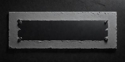 The primary subject of the image is a large, rectangular piece of cement. The setting is a dark background, which contrasts with the cement. The visual style is a close-up of the cement, showcasing its texture and details. The colors and mood of the image are predominantly dark, with the cement being the main focus.