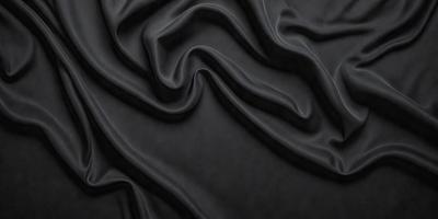 The primary subject of the image is a close-up of a black fabric, possibly a piece of clothing or a curtain. The setting is a dark background, which emphasizes the fabric's texture and pattern. The visual style appears to be a photo, as it captures the details of the fabric. The colors and mood of the image are predominantly dark, with the black fabric being the main focus.