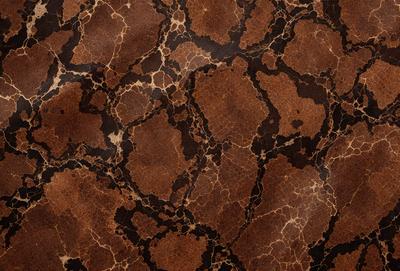 The primary subject of the image is a brown and black marbled pattern, which is the main object, scene, or focus of the image. The setting or background is a brown and black marbled surface, which is visible. The visual style of the image is a photo, as it is a close-up of the marbled pattern. The dominant colors and overall atmosphere of the image are brown and black, giving it a rich and textured appearance.