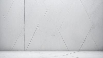 The primary subject of the image is a white wall with a pattern of Xs on it. The setting is a room with a concrete floor. The visual style is a photo, and the colors and mood are predominantly white, giving the image a clean and minimalist appearance.