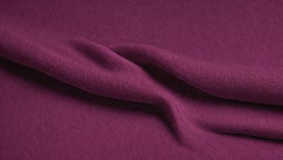 The primary subject of the image is a purple fabric, which is the main object, scene, or focus of the image. The setting or background is a purple surface, which adds to the overall atmosphere of the image. The visual style of the image is a close-up of the purple fabric, showcasing its texture and details. The colors and mood of the image are predominantly purple, creating a calm and soothing atmosphere.