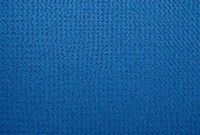 The primary subject of the image is a blue fabric with a pattern of interlocking diamond shapes. The setting is a blue background, and the visual style appears to be a close-up of the fabric. The colors and mood of the image are predominantly blue, creating a calm and serene atmosphere.