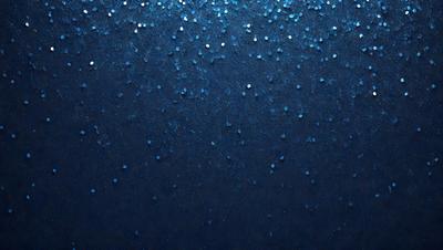 The primary subject of the image is a blue background with a pattern of glittering stars. The setting is a dark, starry night, and the visual style is a combination of a photo and digital art. The colors and mood of the image are predominantly dark and moody, with the blue background and glittering stars creating a sense of depth and mystery.