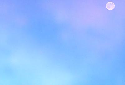The primary subject of the image is a cloudy blue sky. The setting is a vast expanse of the sky, with no visible land or other objects. The visual style is a natural, outdoor scene. The colors and mood are predominantly blue and calm, with a hint of tranquility.