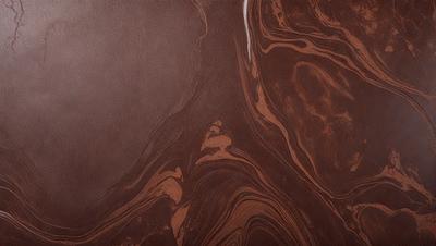 The primary subject of the image is a close-up of a brown, swirling pattern on a surface. The setting appears to be a dark room, with the pattern being the main focus of the image. The visual style is a close-up of the pattern, which gives it a textured and detailed appearance. The colors and mood of the image are predominantly dark and moody, with the brown swirls creating a sense of depth and intrigue.