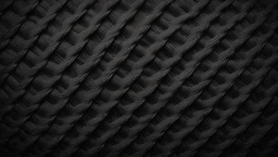 The primary subject of the image is a close-up of a black rope. The setting is a black background, which creates a striking contrast with the rope. The visual style is a close-up of the rope, emphasizing its texture and details. The colors and mood of the image are predominantly black, giving it a bold and dramatic appearance.