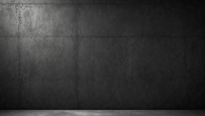 The primary subject of the image is a large concrete wall. The setting is a dark room with a concrete surface. The visual style is a black and white photo. The dominant colors are gray and black, creating a moody atmosphere.