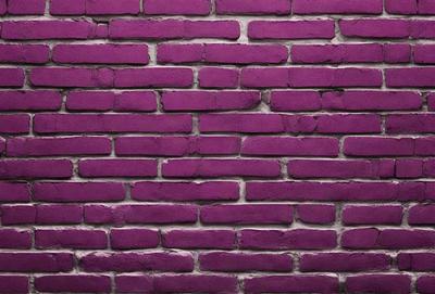 The primary subject of the image is a purple brick wall. The setting is a brick wall, and the visual style is a photo. The dominant colors are purple and pink, creating a warm and inviting atmosphere.