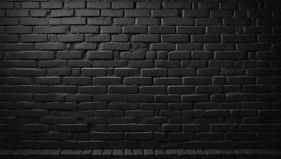 The primary subject of the image is a black brick wall. The setting is a dark room, and the visual style is a photo. The dominant colors are black and white, creating a moody atmosphere.