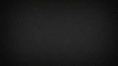 The image is a black and white photo of a dark background.