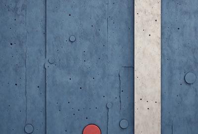 The primary subject of the image is a blue wall with a red circle on it. The setting is a concrete wall, and the visual style appears to be a photo. The dominant colors are blue and red, creating a bold and striking contrast. The overall atmosphere of the image is modern and artistic.