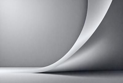 The primary subject of the image is a large, curved, white surface. The setting is a white wall, and the visual style is a photo. The colors and mood of the image are predominantly white, giving it a clean and minimalist appearance.