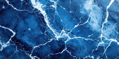 The primary subject of the image is a blue and white marbled surface, which appears to be a wall or a piece of art. The setting is a room with a blue and white marbled wall, and the visual style is a close-up of the marbled surface. The colors and mood of the image are predominantly blue and white, creating a calm and serene atmosphere.