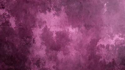 The primary subject of the image is a purple wall with a pattern of white spots. The setting is a room with a purple wall, and the visual style is a close-up of the wall. The dominant colors are purple and white, creating a calm and soothing atmosphere.