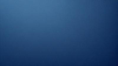 The primary subject of the image is a large, empty blue sky. The setting is a vast, open space with no visible landmarks or objects. The visual style is a simple, uncluttered representation of the sky. The colors and mood are predominantly blue, creating a calm and serene atmosphere.