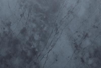 The primary subject of the image is a close-up of a grey stone wall. The setting is a dark room, and the visual style appears to be a photo. The dominant colors are grey and black, creating a moody atmosphere.