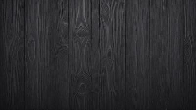 The primary subject of the image is a wooden floor with a unique pattern. The setting is a room with a black background, which emphasizes the wooden floor. The visual style is a close-up of the wooden floor, showcasing its intricate design. The colors and mood of the image are predominantly black, giving it a modern and sophisticated appearance.