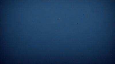 The primary subject of the image is the sky, which is a deep shade of blue. The setting is a vast, open space with no visible landmarks or objects. The visual style is a black and white photo, giving the image a classic and timeless appearance. The colors and mood of the image are serene and peaceful, as the sky is void of any distractions or elements.