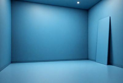 The primary subject of the image is a large, empty room with a blue wall. The setting is a room with a blue wall, and the visual style is a photo. The dominant colors in the image are blue, and the overall atmosphere is calm and serene.