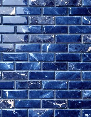 The primary subject of the image is a blue tile wall with a marbled pattern. The setting is a room with a blue tile wall as the main focus. The visual style is a close-up of the blue tile wall, showcasing its intricate design. The colors and mood of the image are predominantly blue, creating a calm and serene atmosphere.