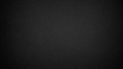 The primary subject of the image is a black background. The setting is a dark, empty space with no visible objects or elements. The visual style is a simple, monochromatic design. The colors and mood are predominantly dark and moody, creating a sense of mystery or drama.