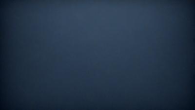 The primary subject of the image is a large, dark blue sky. The setting is a vast, open space with no visible landmarks or objects. The visual style is a simple, unadorned representation of the sky. The colors and mood are predominantly dark and moody, with the blue hue creating a sense of depth and vastness.