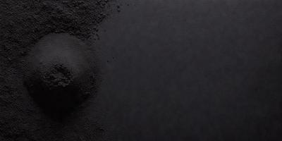 The primary subject of the image is a black and white photo of a black surface. The setting is a black background, and the visual style is a close-up of the black surface. The colors and mood of the image are predominantly black, creating a stark and dramatic atmosphere.