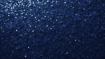 The primary subject of the image is a blue background with a pattern of white circles. The setting appears to be a dark room, and the visual style is a close-up of the blue background with the white circle pattern. The colors and mood of the image are predominantly dark and moody, with the blue background and white circles creating a striking contrast.