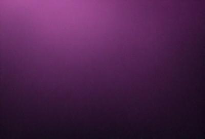 The primary subject of the image is a purple wall. The setting is a dark room, and the visual style appears to be a photo. The dominant colors are purple and black, creating a moody atmosphere.