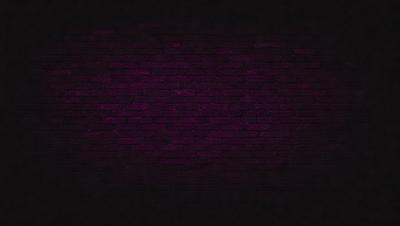 The primary subject of the image is a purple brick wall. The setting is a dark room, and the visual style appears to be a photo. The dominant colors are purple and black, creating a moody atmosphere.