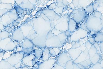The primary subject of the image is a blue and white marbled wall. The setting is a room with a blue and white marbled wall as the main focus. The visual style is a photo of the marbled wall. The dominant colors are blue and white, creating a calm and soothing atmosphere.