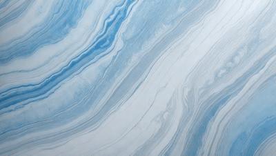 The primary subject of the image is a blue and white marbled tile. The setting is a wall with the tile covering it. The visual style is a close-up of the tile, showcasing its intricate design. The dominant colors are blue and white, creating a calm and soothing atmosphere.