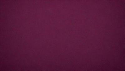 The primary subject of the image is a large, purple surface. The setting is a dark room, and the visual style is a close-up of the purple surface. The colors and mood of the image are predominantly purple, creating a calm and serene atmosphere.