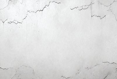 The primary subject of the image is a large, white, textured wall. The setting is a room with a cement-like surface, which adds to the overall atmosphere. The visual style is a close-up of the wall, showcasing its texture and details. The colors in the image are predominantly white, giving the scene a clean and minimalist appearance.