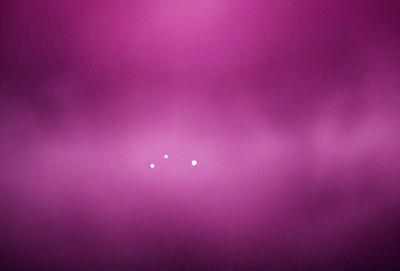 The primary subject of the image is a purple background with a pink hue. The setting is a cloudy sky, which serves as the backdrop for the scene. The visual style of the image is a combination of photo and digital art, creating a unique and artistic representation of the cloudy sky. The dominant colors in the image are purple and pink, giving it a warm and inviting atmosphere.