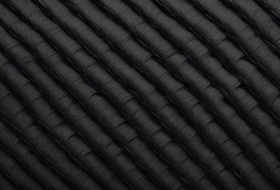 The primary subject of the image is a black fabric with a pattern of interwoven lines. The setting is a close-up view of the fabric, showcasing its intricate design. The visual style is a detailed, textured representation of the fabric, which gives it a unique and artistic appearance. The colors and mood of the image are predominantly black, creating a sense of depth and sophistication.