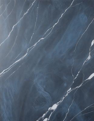 The primary subject of the image is a marble countertop with a blue and white pattern. The setting is a kitchen, and the visual style is a close-up of the countertop. The colors and mood of the image are predominantly blue and white, creating a clean and elegant atmosphere.