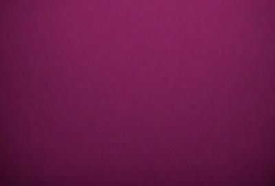 The primary subject of the image is a purple background. The setting is a dark room, and the visual style appears to be a photo. The dominant colors are purple and dark, creating a moody atmosphere.