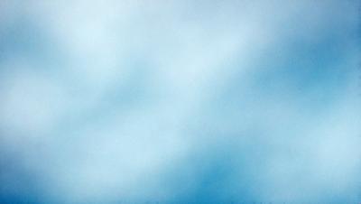 The primary subject of the image is a cloudy blue sky. The setting is a vast expanse of the sky, with no visible land or objects. The visual style is a natural, outdoor scene. The colors and mood are predominantly blue, creating a calm and serene atmosphere.