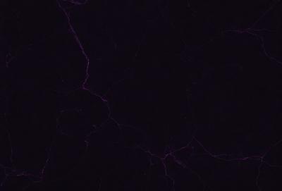 The image is a purple and black photo of a marble-like surface. The primary subject is the marble-like surface, which is the setting and background of the image. The visual style is a photo, and the colors and mood are dominated by the purple and black tones.