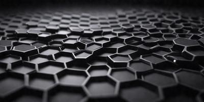 The primary subject of the image is a close-up of a black and white patterned surface, which appears to be a textured or patterned material. The setting is a dark background, which contrasts with the patterned surface. The visual style of the image is a close-up, which emphasizes the details of the pattern. The colors and mood of the image are predominantly black and white, giving it a classic and timeless feel.