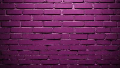 The primary subject of the image is a purple brick wall. The setting is a brick wall, and the visual style is a photo. The dominant colors are purple and pink, creating a warm and inviting atmosphere.