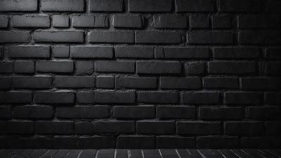 The primary subject of the image is a black brick wall. The setting is a dark room, and the visual style is a photo. The dominant colors are black and grey, creating a moody atmosphere.