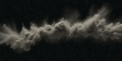 The primary subject of the image is a cloud of dust or smoke, which appears to be a black and white photo. The setting is a dark background, and the visual style suggests a more artistic or dramatic representation of the scene. The colors and mood of the image are predominantly dark and moody, with the cloud of dust or smoke being the main focus.