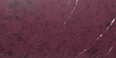 The primary subject of the image is a marbled surface, which appears to be a wall or a countertop. The setting is indoors, with the marbled surface being the main focus of the image. The visual style is a close-up of the marbled surface, showcasing its intricate patterns and textures. The colors and mood of the image are predominantly red, giving it a warm and inviting atmosphere.