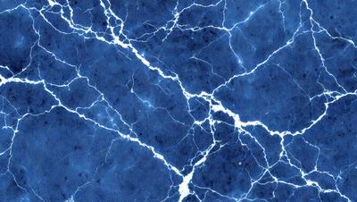 The primary subject of the image is a blue marble surface with white veins. The setting is a blue background, and the visual style is a close-up of the marble surface. The colors and mood of the image are predominantly blue and white, creating a serene and calming atmosphere.