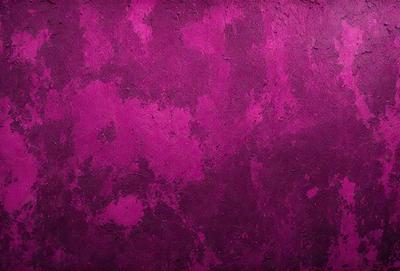 The primary subject of the image is a purple wall with a pinkish hue. The setting is a room with a purple wall, and the visual style is a close-up of the wall. The dominant colors and overall atmosphere are a mix of purple and pink, creating a warm and inviting ambiance.