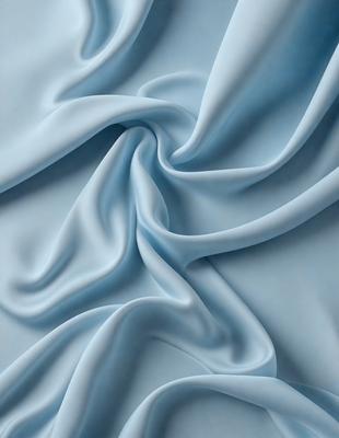 The primary subject of the image is a blue fabric, which appears to be a piece of cloth or a sheet. The setting is a blue background, which complements the blue fabric. The visual style is a close-up of the fabric, showcasing its texture and details. The colors and mood of the image are predominantly blue, creating a calm and serene atmosphere.