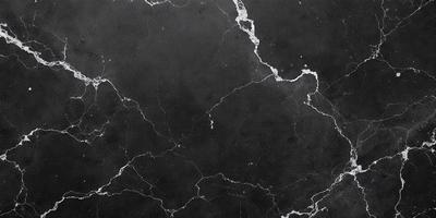 The image features a black marble surface with a pattern of white lines. The marble surface appears to be a part of a wall or a countertop. The black and white color scheme creates a striking contrast, giving the scene a modern and elegant appearance.
